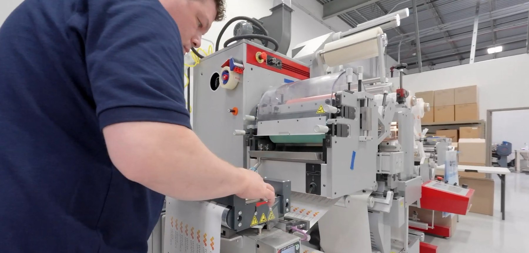 A White Graphics operator running the digital label press